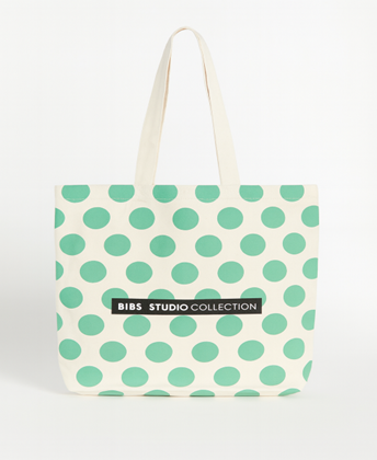 Tote bag with green polka dots on a white background